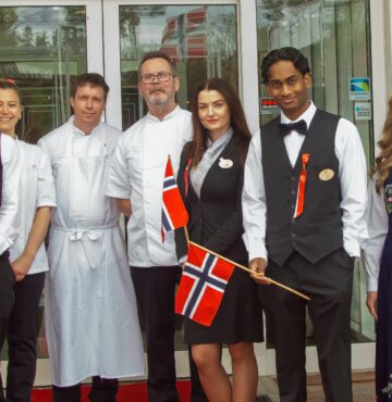 Personalet på Losby Gods, på rød løper foran hovedinngangen, 17. mai 2023